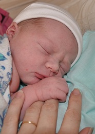 Newborn holding finger