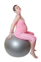 Pregnant woman sitting on an exercise ball