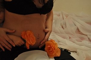 Flowers and hands on belly
